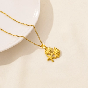 Detailed close-up of golden O-chain necklace with seashell, conch and starfish charms