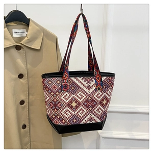 Close-up of ethnic tote bag with geometric woven fabric and durable leather bottom