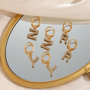 Detailed macro view of 18K gold plated letter Z, R, Y earrings with micro-set zircons