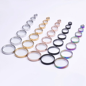 Various sizes of round stainless steel glass lockets in five colors on white background