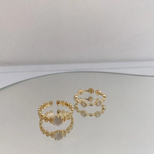 Vintage style gold cat's eye stone open rings on a decorative mirror display