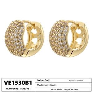 Close-up of gold-plated brass huggie earrings with pave zircons and heart cut-outs