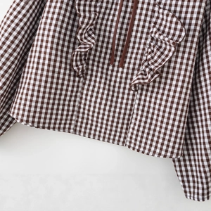 Brown plaid long sleeve shirt with tiered ruffle trim and drawstring neckline detail