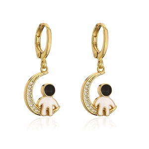 Detail of gold astronaut and moon earrings with white cubic zirconia and black accents