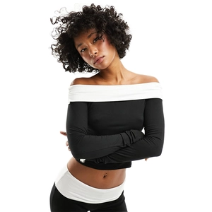 Detail of slim fit off-shoulder long sleeve top with contrast black and white design