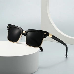 Classic black and gold clubmaster sunglasses with square lenses on a white display pedestal
