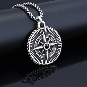 Macro view of vintage viking compass pendant with antique silver finish and pearl chain