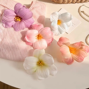 Five assorted faux tulip hair clips in pastel colors with a soft feminine aesthetic