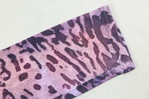 Detailed macro view of purple leopard print pattern and high-quality double stitching