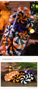 Macro shot of spiral striped candy-shaped ornaments in orange, black, and white colors