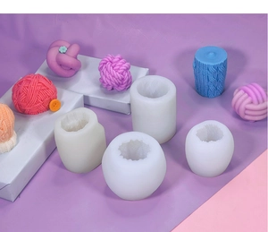 Detail showing silicone molds and textured yarn ball candle models for DIY baking crafts