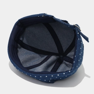 Detail of blue polka dot docker cap showing interior lining and adjustable strap