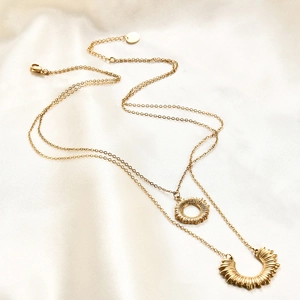 Detailed view of layered 18K gold-plated double-layer necklace with sun pendants on silk