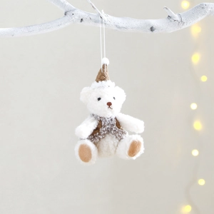 Christmas bear plush pendant with brown hat and grey vest hanging on a white branch