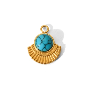Detailed macro view of gold-plated sunburst pendant featuring a vibrant turquoise stone inlay