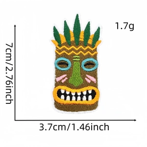 Detail showing Tiki mask embroidery patch with size dimensions and precise stitching