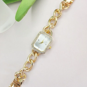 Detail of rectangular gold watch with diamond bezel and stylish chain link strap