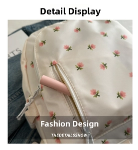 Detail of floral backpack with pink flowers and a front zipper pocket for small items