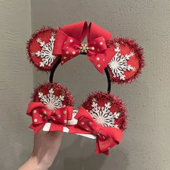 Close-up of red Christmas Mickey-style headband with glitter ears and gold polka dot bow