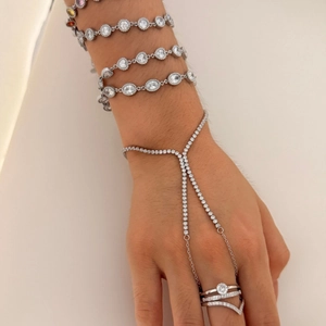 Exquisite stainless steel bracelet set with heart zircons on model's hand with white background