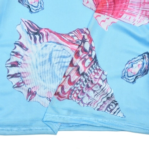 Detail of seashell print on light blue polyester fabric with high-quality stitching edges