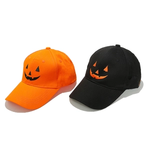 Detailed view of Halloween baseball caps with embroidered orange and black pumpkin faces