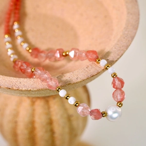 Handmade beaded necklace with pink faceted stones, white pearls and gold spacers