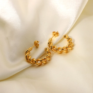 18K gold plated stainless steel twisted croissant hoop earrings on silk background