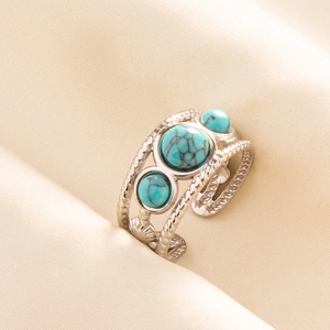 Detail of silver adjustable ring with braided rope texture and three turquoise stones