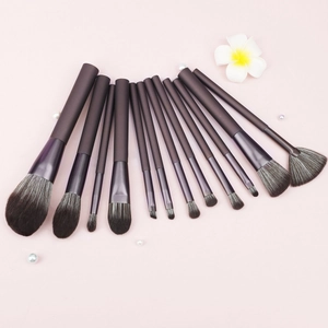 Elegant 13-piece makeup brush set with coffee handles and soft gradient bristles on pink background