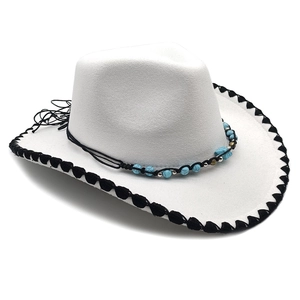 Detail of white felt cowboy hat with turquoise beads and black stitched brim