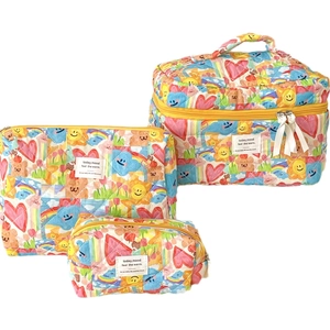 Three-piece quilted cotton makeup bag set with colorful graffiti prints and carry handle