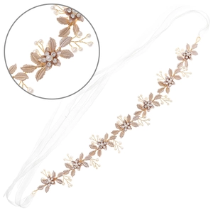 Detailed macro view of bridal headband with gold alloy leaves and delicate pearls