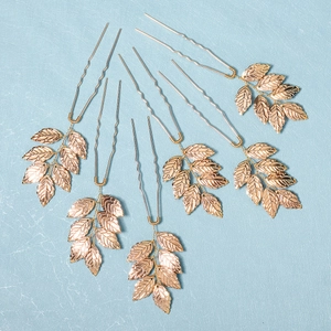 6-piece gold leaf bridal hair pins set for weddings and hair styling on blue background