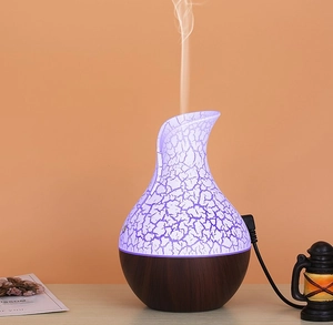 Detail of wood grain aromatherapy diffuser with purple crackle light effect and water mist