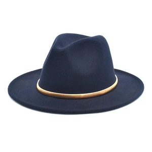 Detailed close-up of dark blue felt fedora featuring a gold-tone metallic buckle band
