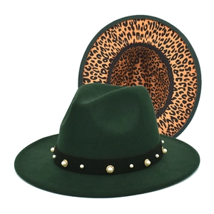 Close-up of wool jazz hat featuring white pearls, gold rivets and leopard print brim