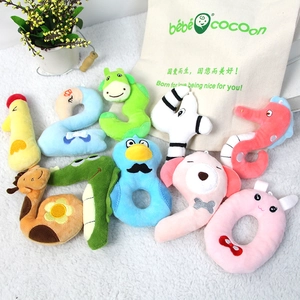 Detail of colorful number 0-9 plush toys with animal features on soft white rug