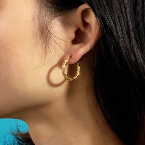 Polished gold stainless steel twisted rope hoop earrings for women with minimalist design