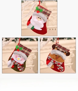 Detailed plush Christmas stockings featuring Santa, Snowman, and Reindeer on a mantel