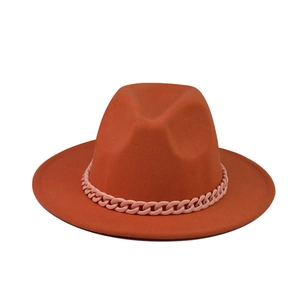 Flat top orange wool felt fedora hat with wide brim and decorative pink chain accessory
