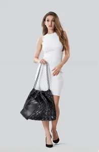 Detail of black woven leather tote bag with silver-tone chain strap and small pouch