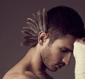 Detailed close-up of a vintage Indian-style peacock feather ear wrap for men and women