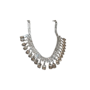 Dramatic square rhinestone tassel necklace with shiny crystals on a white background