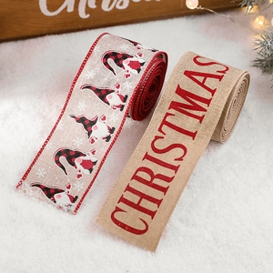 Christmas gnome linen ribbon with red letters on snowy background for festive decor