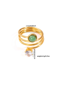 Detail view of gold spiral ring with green gemstone and zircon showing size measurements