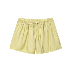 Detail of light yellow textured shorts with elastic waistband and matching drawstring