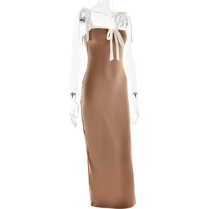Detail view of brown slim fit long dress featuring white lace-up bow and contrast binding