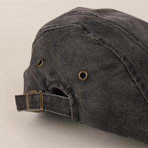 Vintage dark grey washed canvas flat cap featuring adjustable brass buckle and eyelets