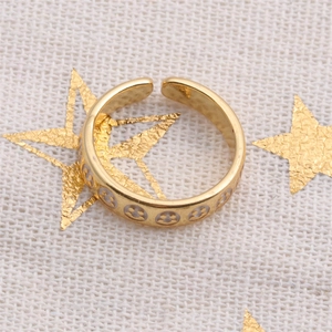 Macro view of gold-plated open ring featuring detailed Mickey Mouse pattern silhouettes